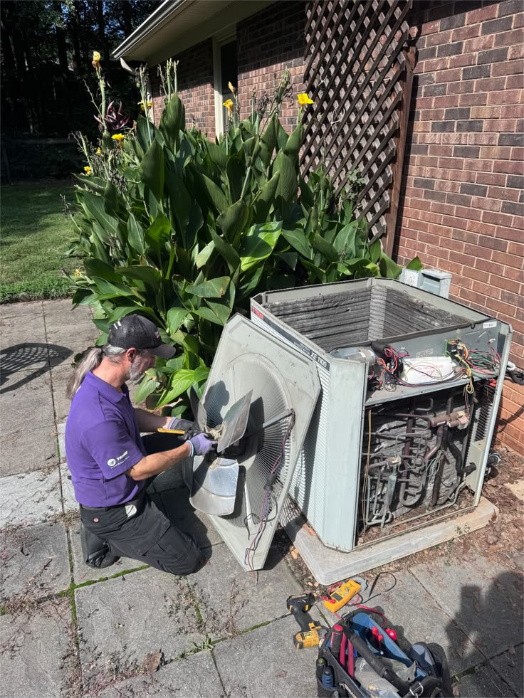 Technician servicing ductwork and internal air handling equipment