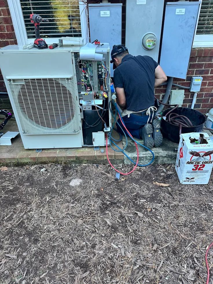 Technician performing an urgent outdoor air conditioning repair