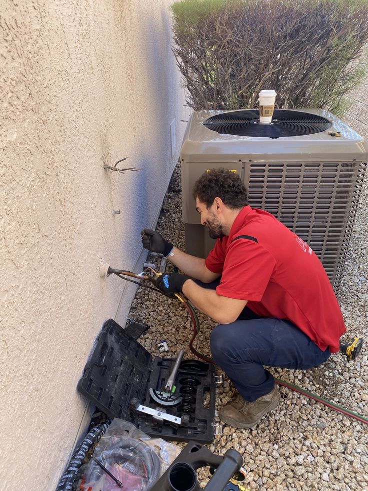 Technician connecting diagnostic equipment to HVAC system controls